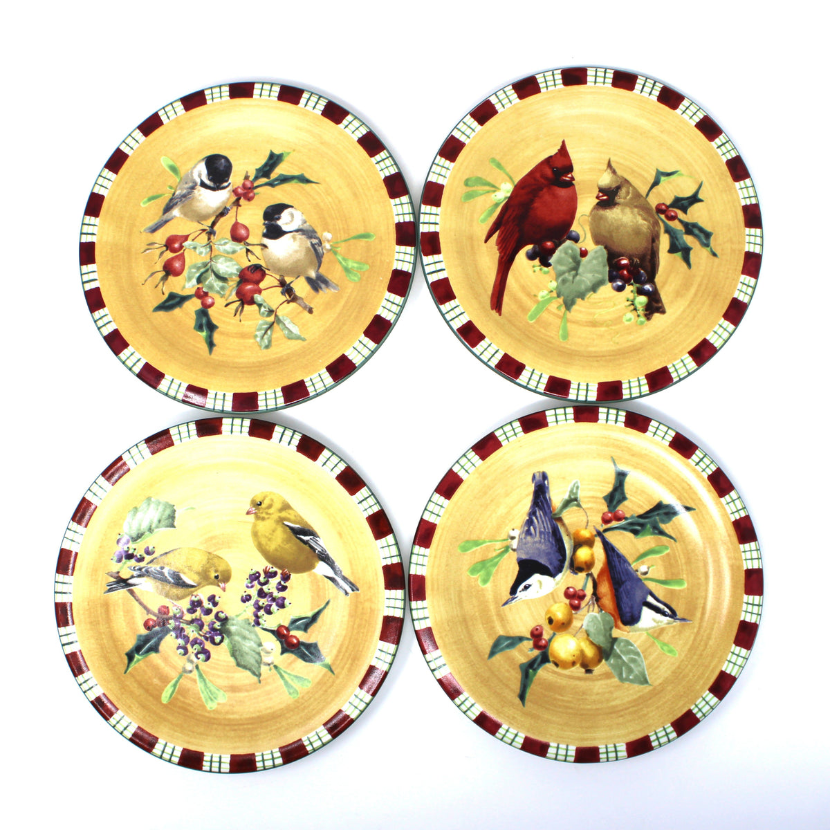 Four round salad plates.  Part of a complete Christmas dinnerware set by Lenox, Winter Greetings Everyday.  With colorful bird illustrations and a red-green-white plaid patterned rim