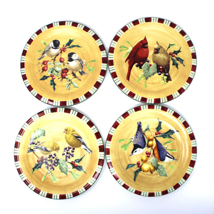 Four round salad plates.  Part of a complete Christmas dinnerware set by Lenox, Winter Greetings Everyday.  With colorful bird illustrations and a red-green-white plaid patterned rim