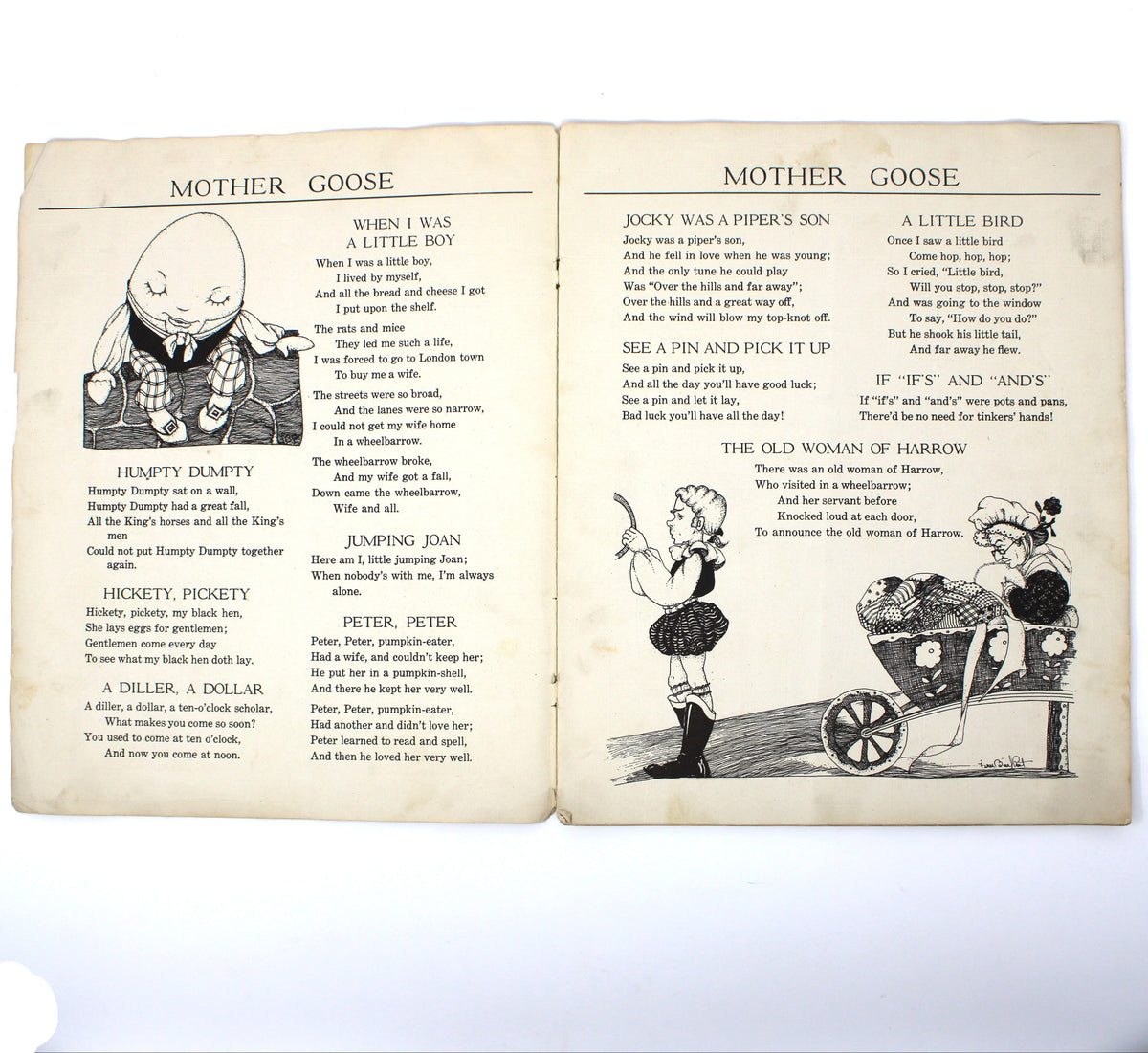 An open vintage book showing printed pages titled 'MOTHER GOOSE' with black illustrations and text on aged cream paper.  Saalfield linen children's book.