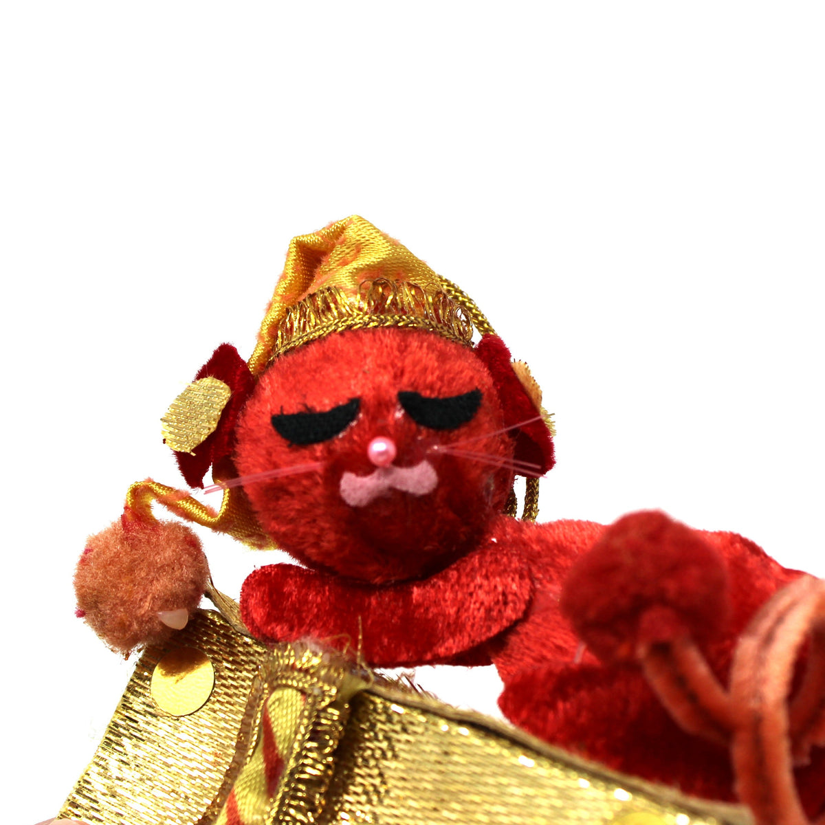 A small red plush monkey toy wearing a shiny gold crown and matching gold robe, posed against a plain white background.