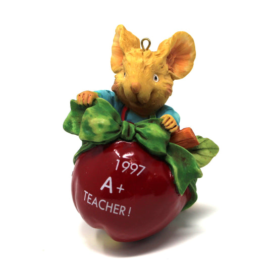 Up close view of a 1997 Carlton cards Christmas ornament for teacher. Mouse holding apple in original box.