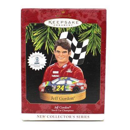 A Hallmark New Collection Series 6 Jeff Gordon 2000 Christmas ornament in its original window box packaging, featuring a red border and a photo of the driver with his race car.