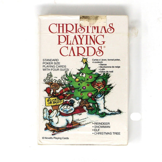 Vintage 'Christmas Playing Cards' box by Novelty Playing Cards, featuring festive illustrations of a Christmas tree, snowman, and reindeer