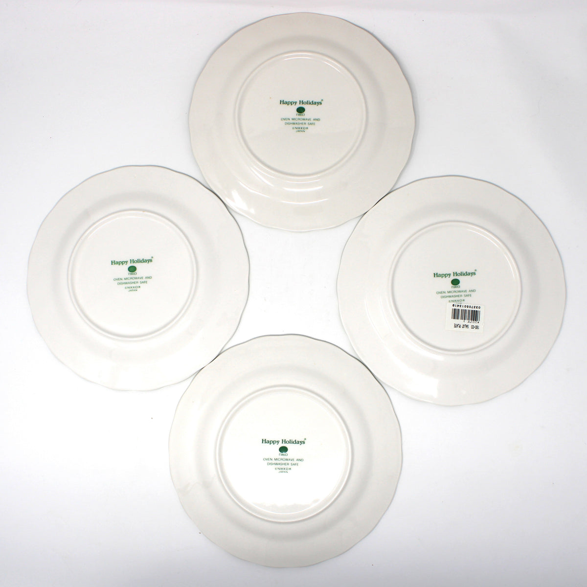 Set of Four vintage white ceramic dinner plates from NIKKO Japan back view of logo.  