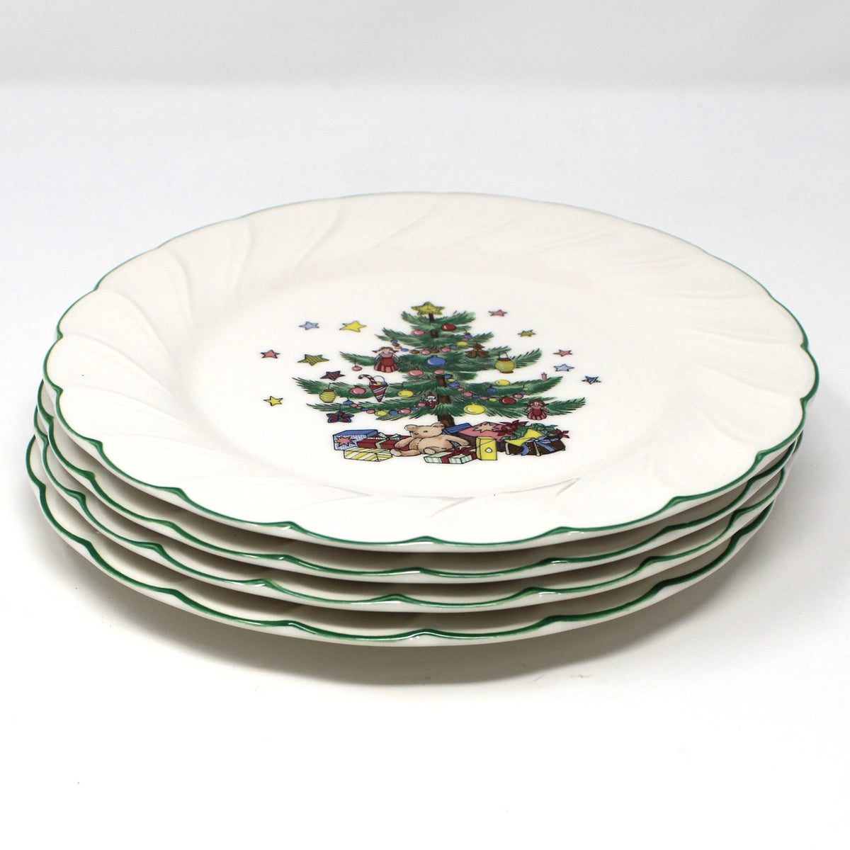 a stack of four vintage NIKKO Happy Holidays Christmas salad plates.