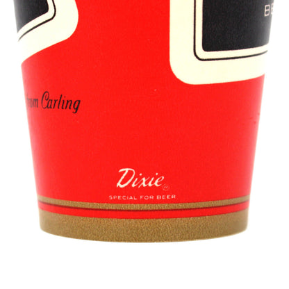 A close-up of a red Dixie cup showing the brand logo and part of the label design on a white background.