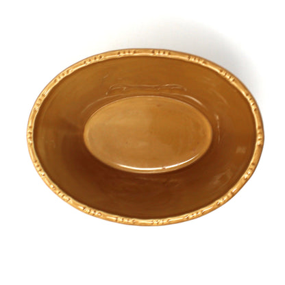 view of the inside of a Hallmark ceramic oval bowl with embossed turkey