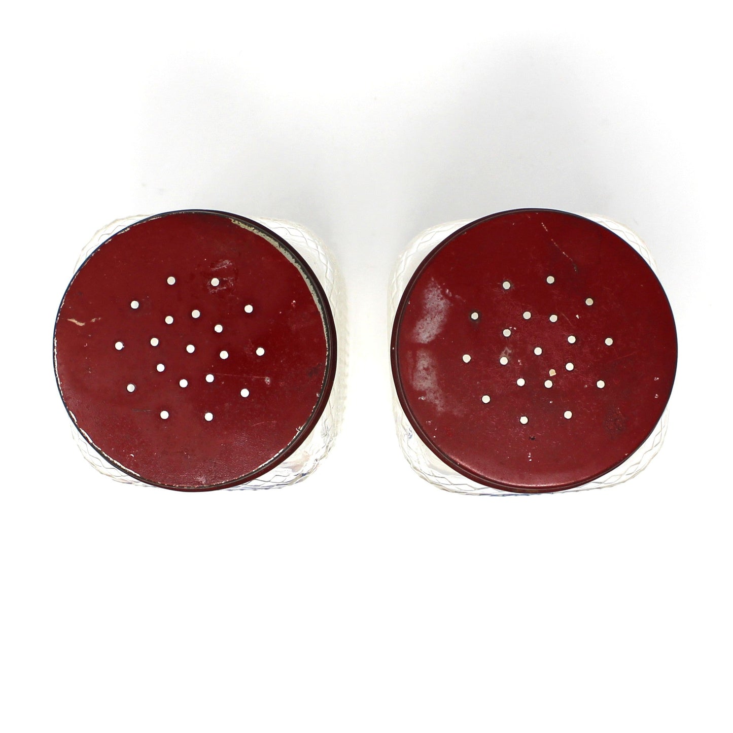 View of red lids from square glass salt and pepper shakers by Hazel Atlas