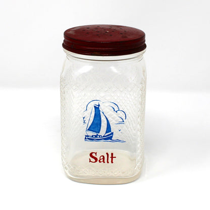 Vintage glass salt shaker with red lid and blue sailboat design.  Waffle glass square jar.